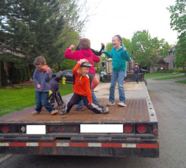 Kids dancing on flat bed truck