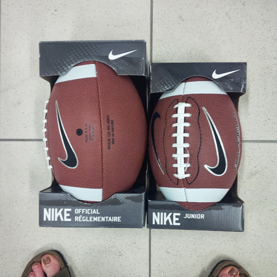 Two different sizes of footballs