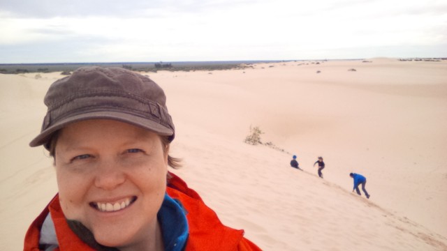 Sand dune selfie! :) Family can be seen sand surfing in the background.